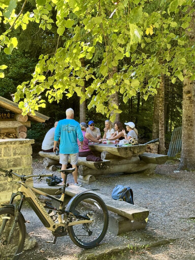 Guests enjoying a local Swiss cheese tasting during the Lake Brienz e-bike tour to Iseltwald and Giessbach