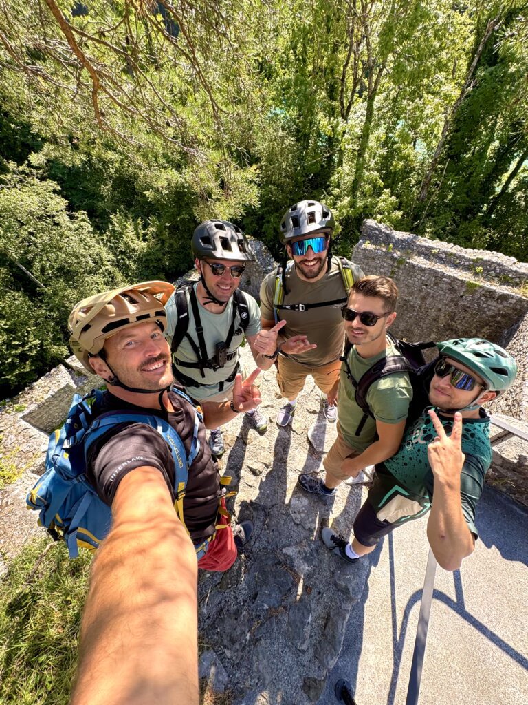 Cycling group selfie at castle ruins on Interlaken E-bike Tour
