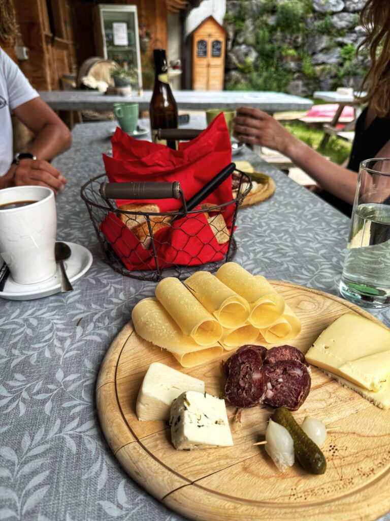 Local Swiss cheese tasting during the Griesalp UNESCO E-bike tour in Kiental, a traditional stop on the Interlaken Swiss Alps adventure.