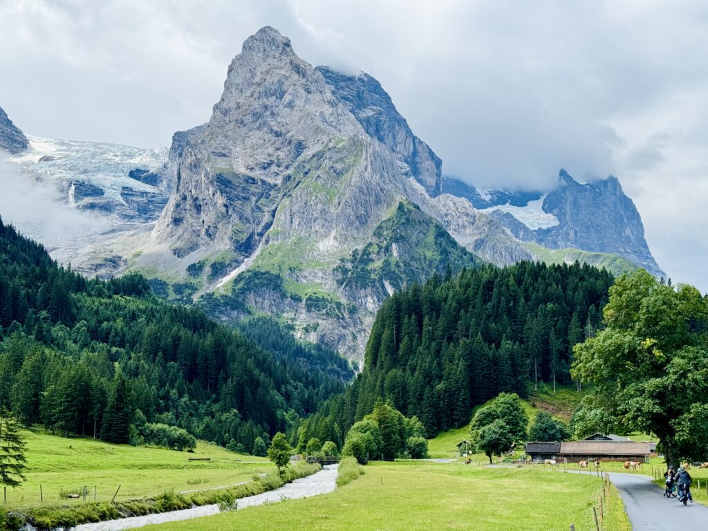 Scenic Rosenlaui Valley landscape with cyclists on the E-bike Tour from Interlaken