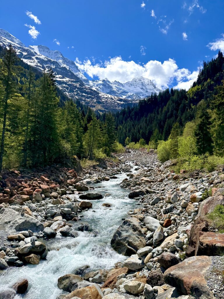 Mountain river and snowy peaks near Trachsellaunen in the Swiss Alps.